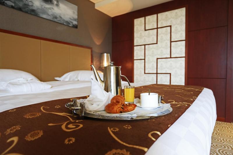 Un ou plusieurs lits dans un hébergement de l'établissement Hôtel Huatian Chinagora