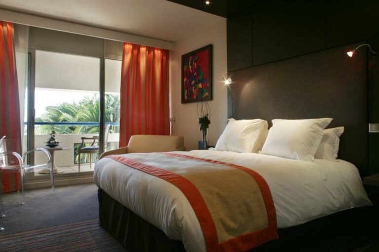 Un ou plusieurs lits dans un hébergement de l’établissement Hôtel & Spa Vatel