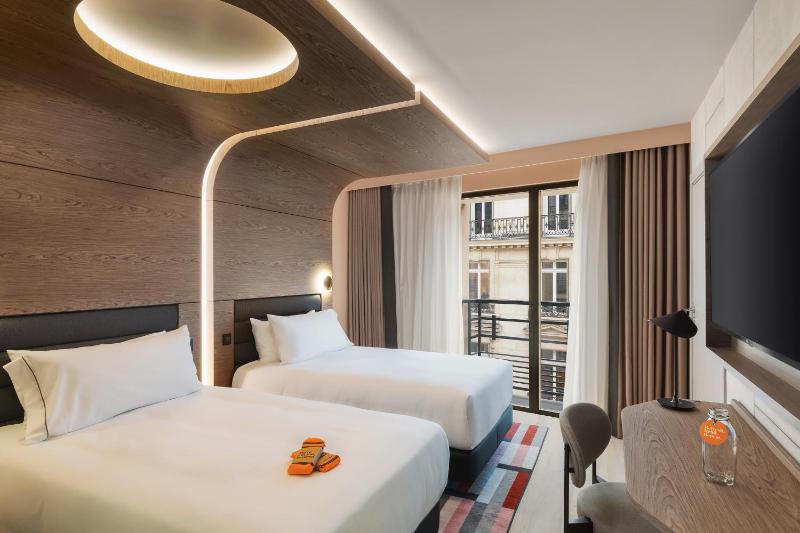 Un ou plusieurs lits dans un hébergement de l'établissement Canopy By Hilton Paris Trocadero