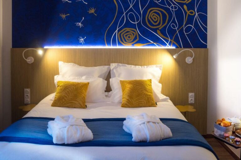 Un ou plusieurs lits dans un hébergement de l’établissement Kyriad Prestige Amiens Poulainville – Hotel and Spa
