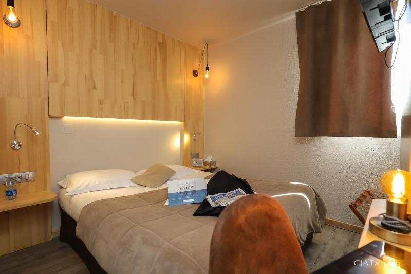 Un ou plusieurs lits dans un hébergement de l'établissement Hotel Restaurant Kyriad Brive Centre